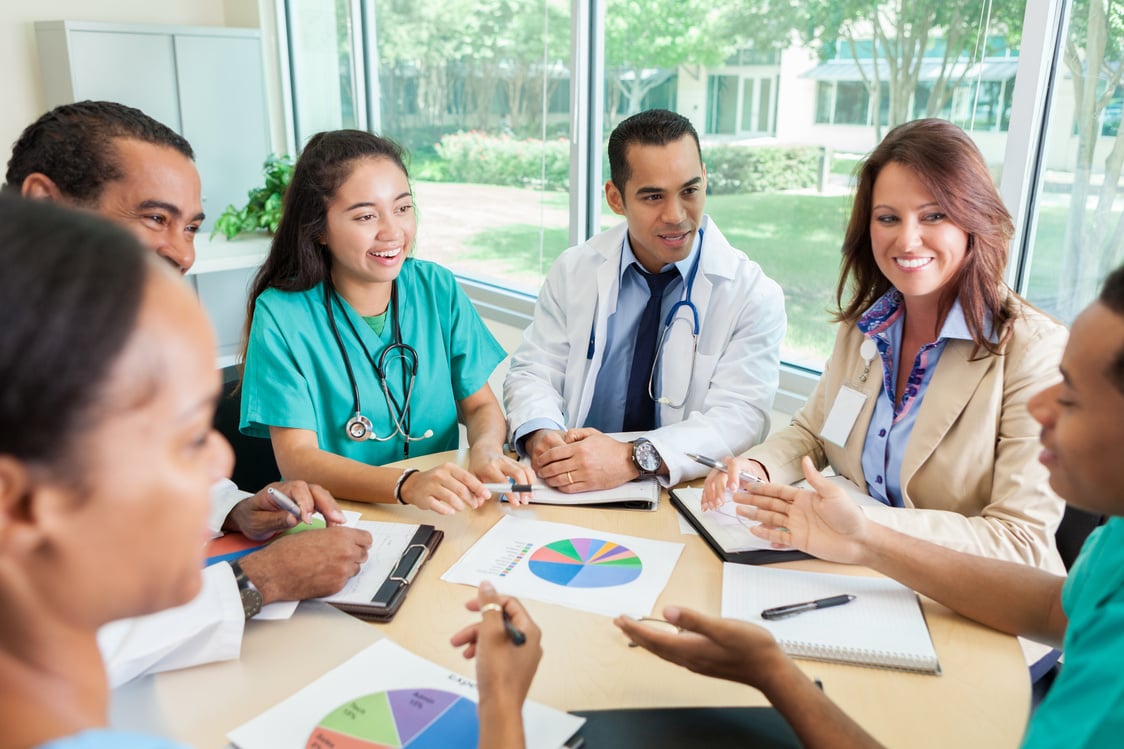 Medical professionals meeting with hospital administrator